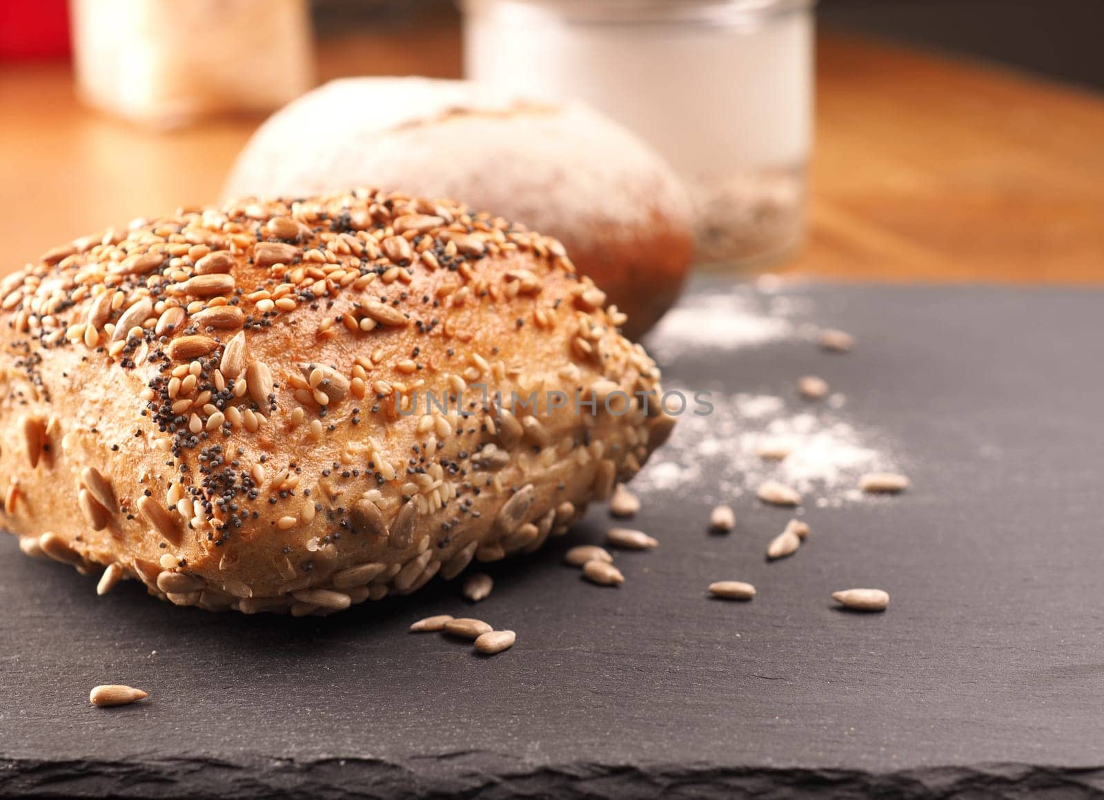 Tasty organic rolls on a dark slate cutting board, natural healthy eating