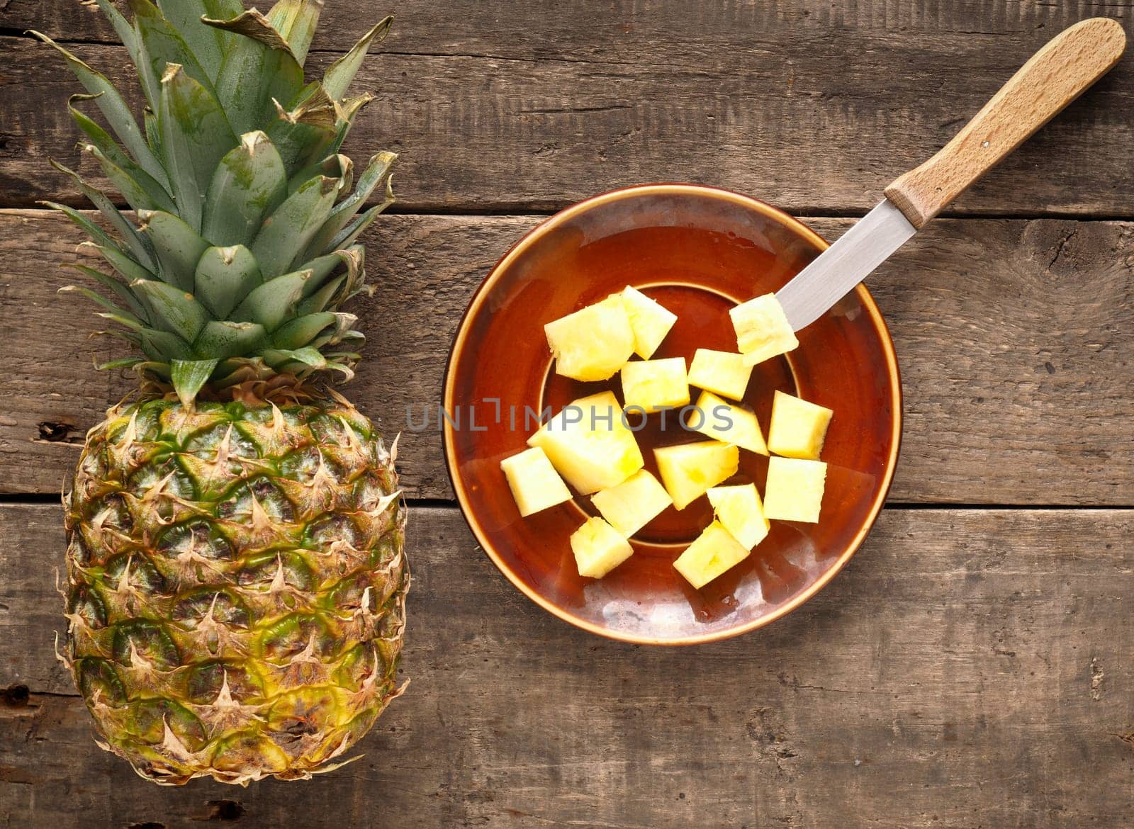 Sweet organic pineapple on a rustic wooden table