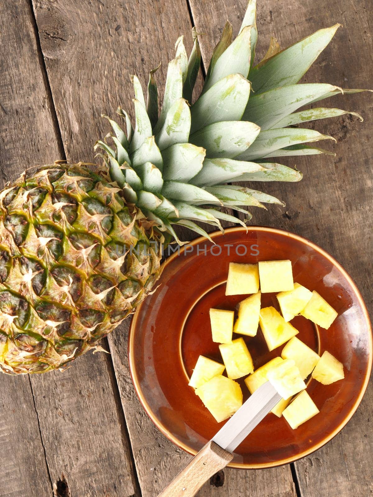 Sweet organic pineapple on a rustic wooden table