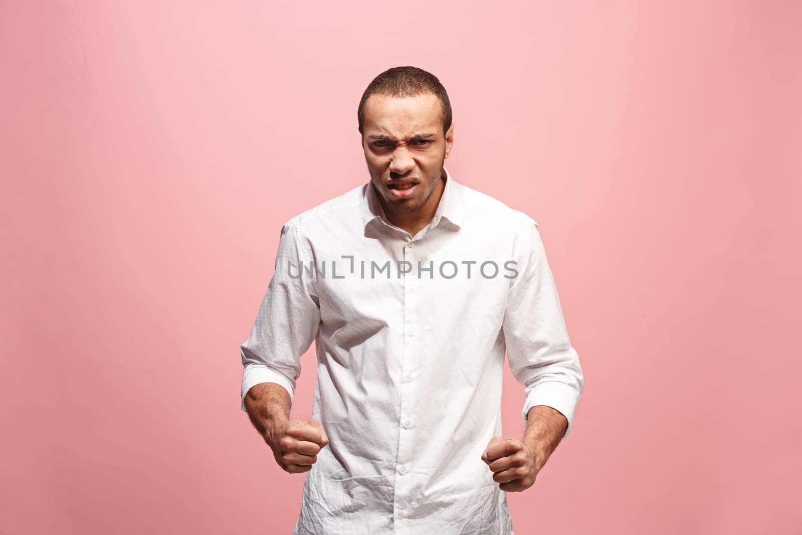 Screaming, hate, rage. Crying emotional angry afro man screaming on pink studio background. Emotional, young face. male half-length portrait. Human emotions, facial expression concept. Trendy colors