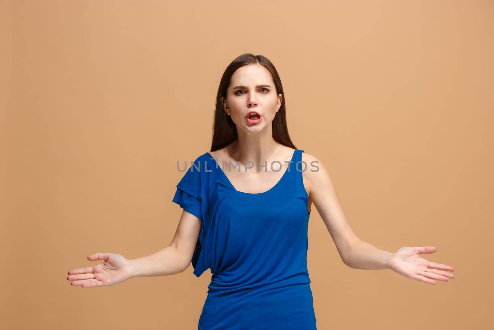 Argue woman. Aggressive angry business woman standing isolated on trendy pastel studio background. Female half-length portrait. Human emotions, facial expression concept. Front view.