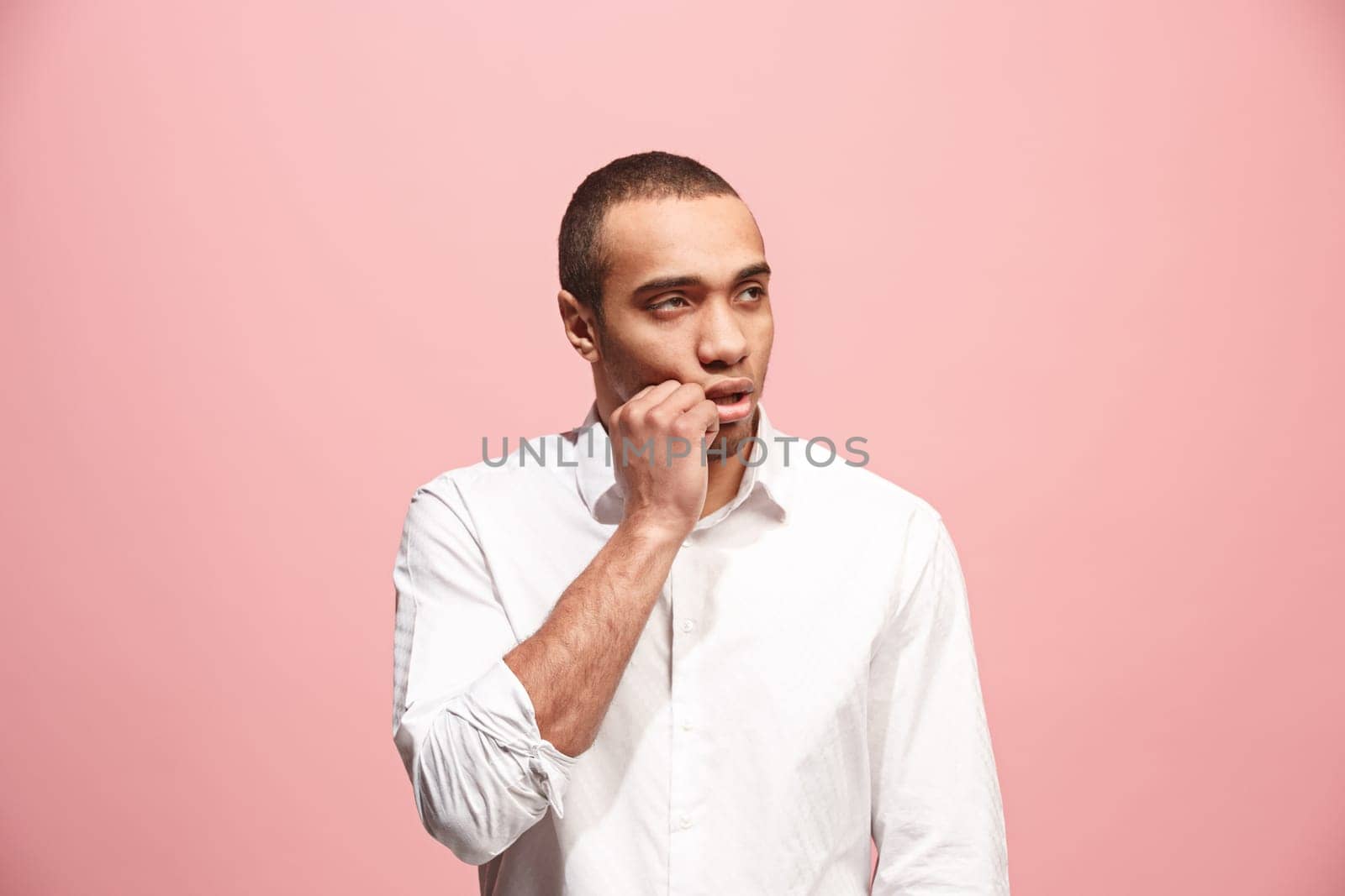 I am tired of everything. Bored man. Boring, dull, tedious concept. Young caucasian emotional afro man. Human emotions, facial expression concept. Studio shot isolated on trendy pink background