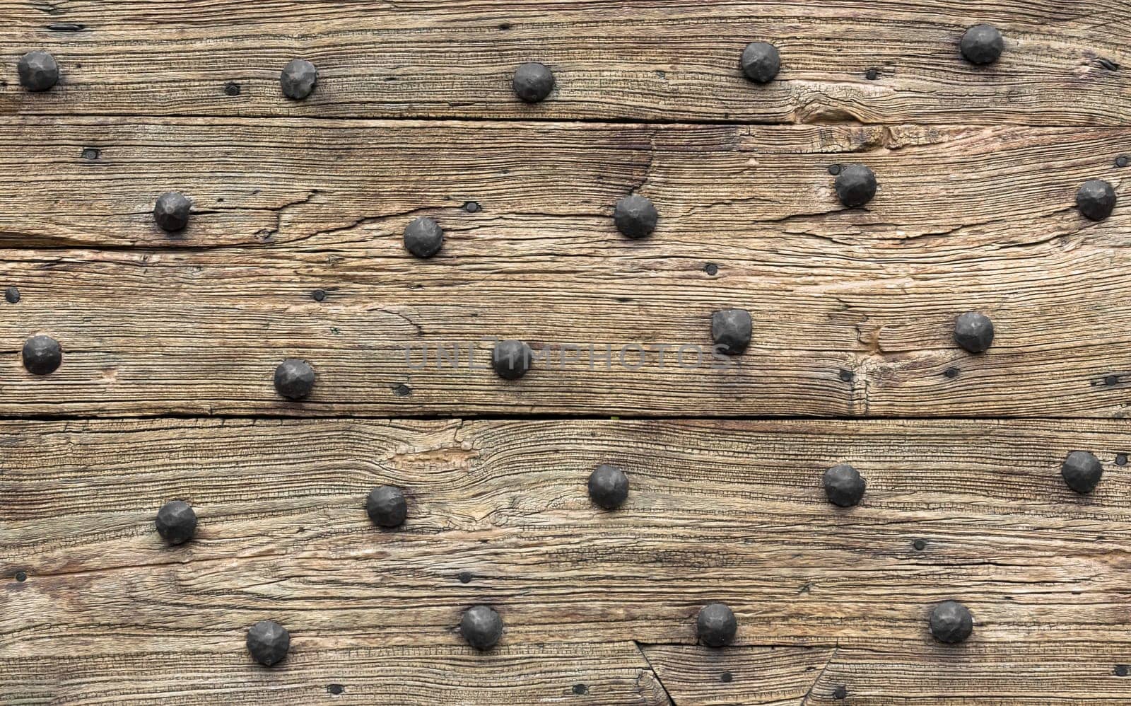 Old door with bronze nails. Ideal for background.