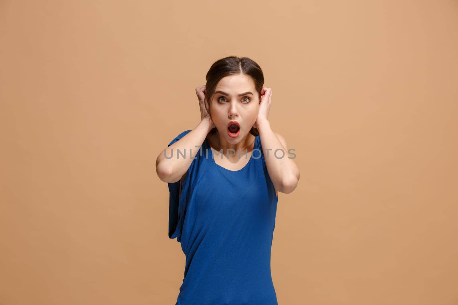 Wow. Beautiful female half-length front portrait isolated on pastel studio backgroud. Young emotional surprised woman standing with open mouth. Human emotions, facial expression concept. Trendy colors
