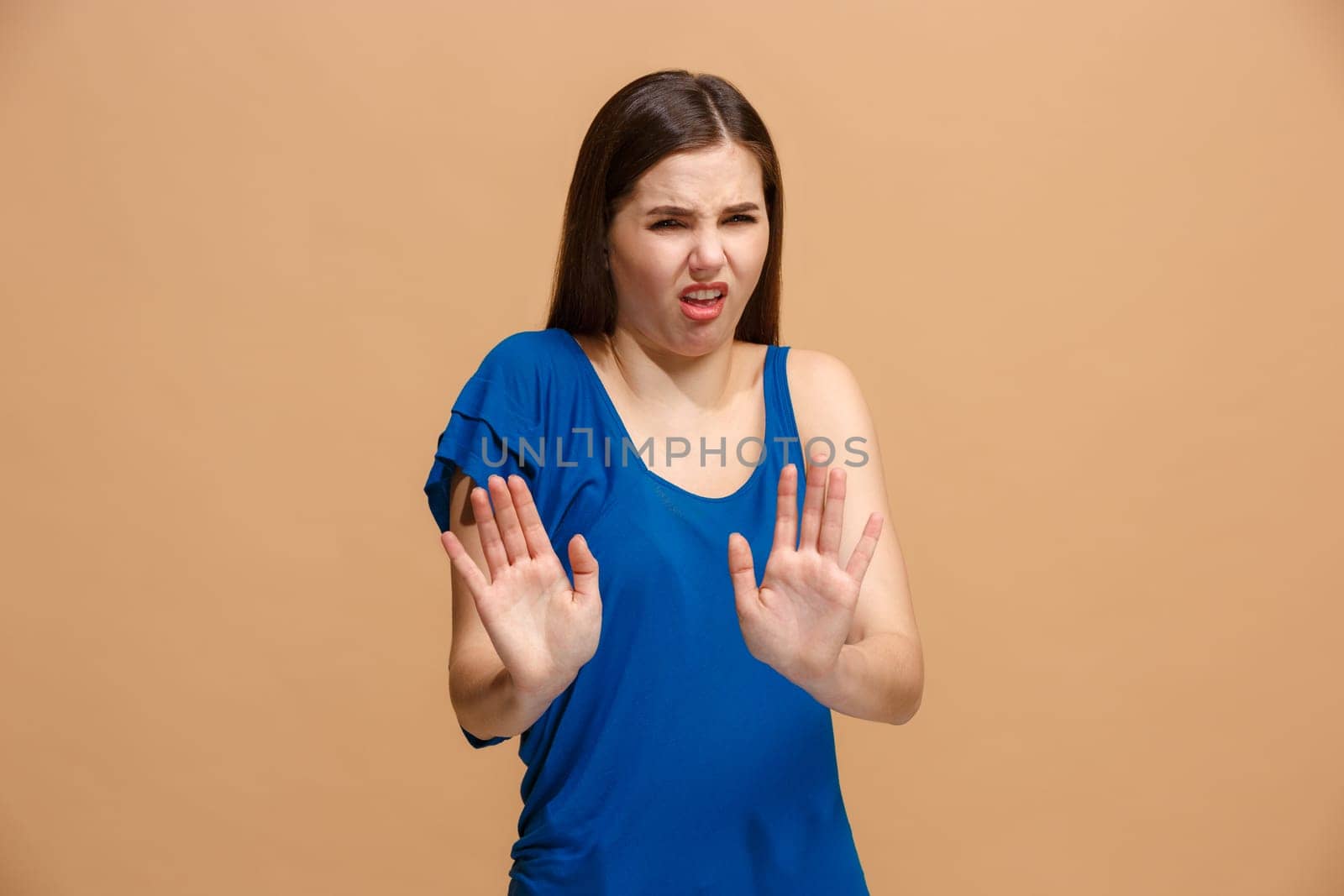 Reject, rejection, doubt concept. Disgust woman with thoughtful expression making choice. Young emotional woman. Human emotions, facial expression concept. Front . Studio. Isolated on trendy pastel