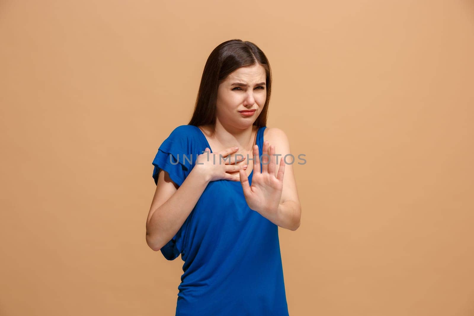 Reject, rejection, doubt concept. Disgust woman with thoughtful expression making choice. Young emotional woman. Human emotions, facial expression concept. Front . Studio. Isolated on trendy pastel