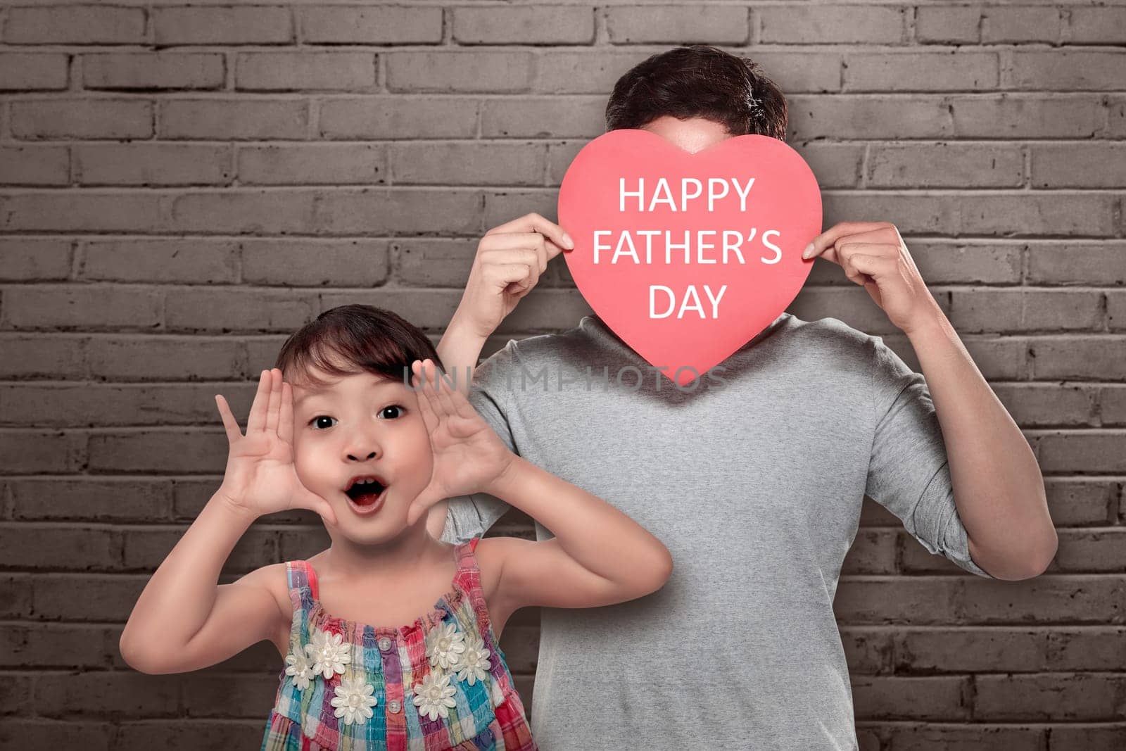 Playful asian little girl with her dad playing together. Fathers day concept