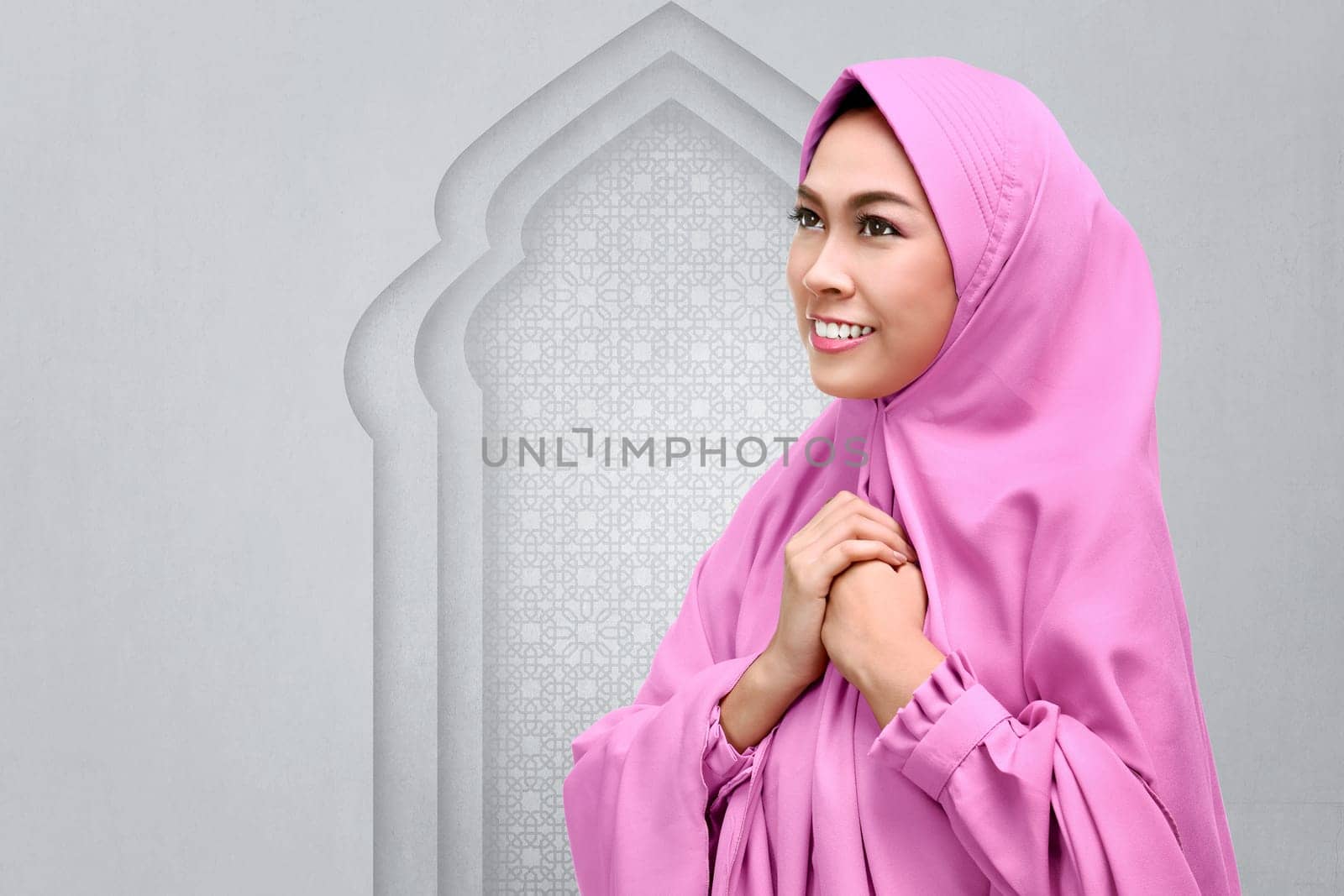 Smiling asian muslim woman pray to god on the mosque