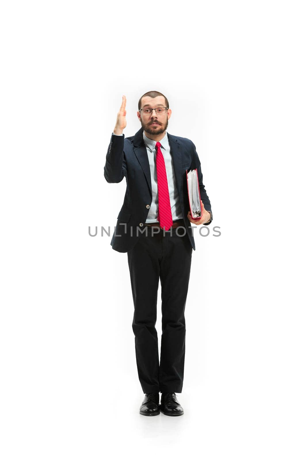 Choose me. Concept of choose the best candidate. Full body view of businessman raising his hand on white studio background. Serious bearded young man in glasses, suit. Business, career concept.