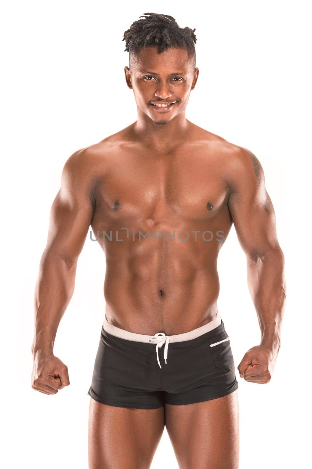 Fit young man with beautiful torso, isolated on white background. The naked torso of African American man posing at studio. The muscular body, fitness, sports, healthy lifestyle and bodybuilder concept.