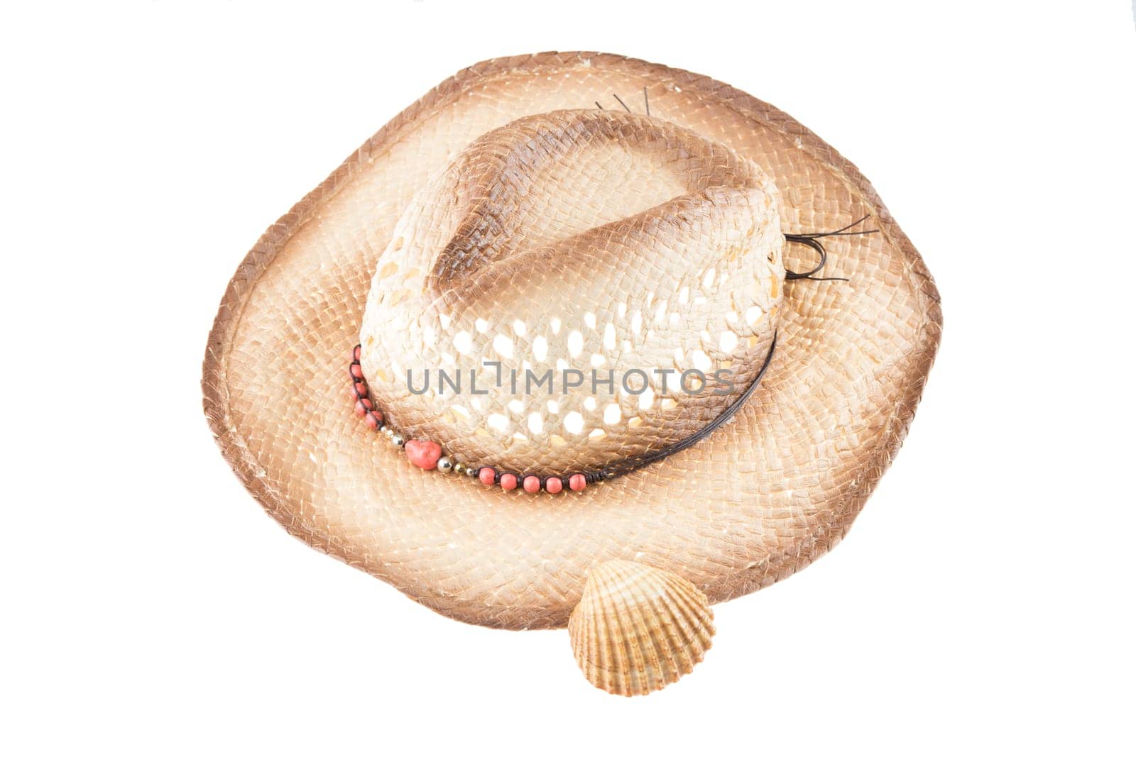 Ladies straw hat decorated with small shell on white background