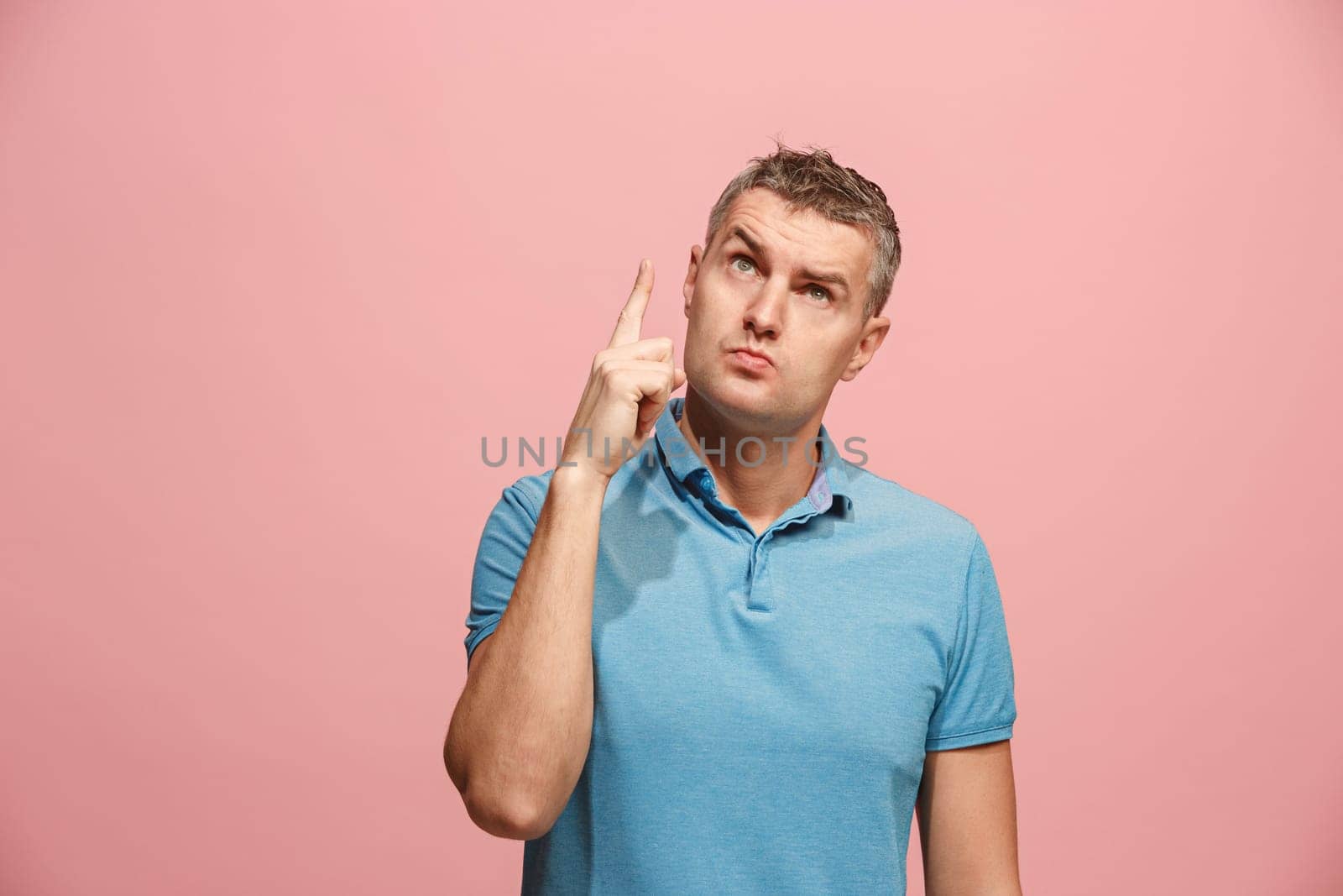 Remember all. Let me think. Doubt concept. Doubtful, thoughtful man remembering something. Young emotional man. Human emotions, facial expression concept. Studio. Isolated on trendy pink. Front