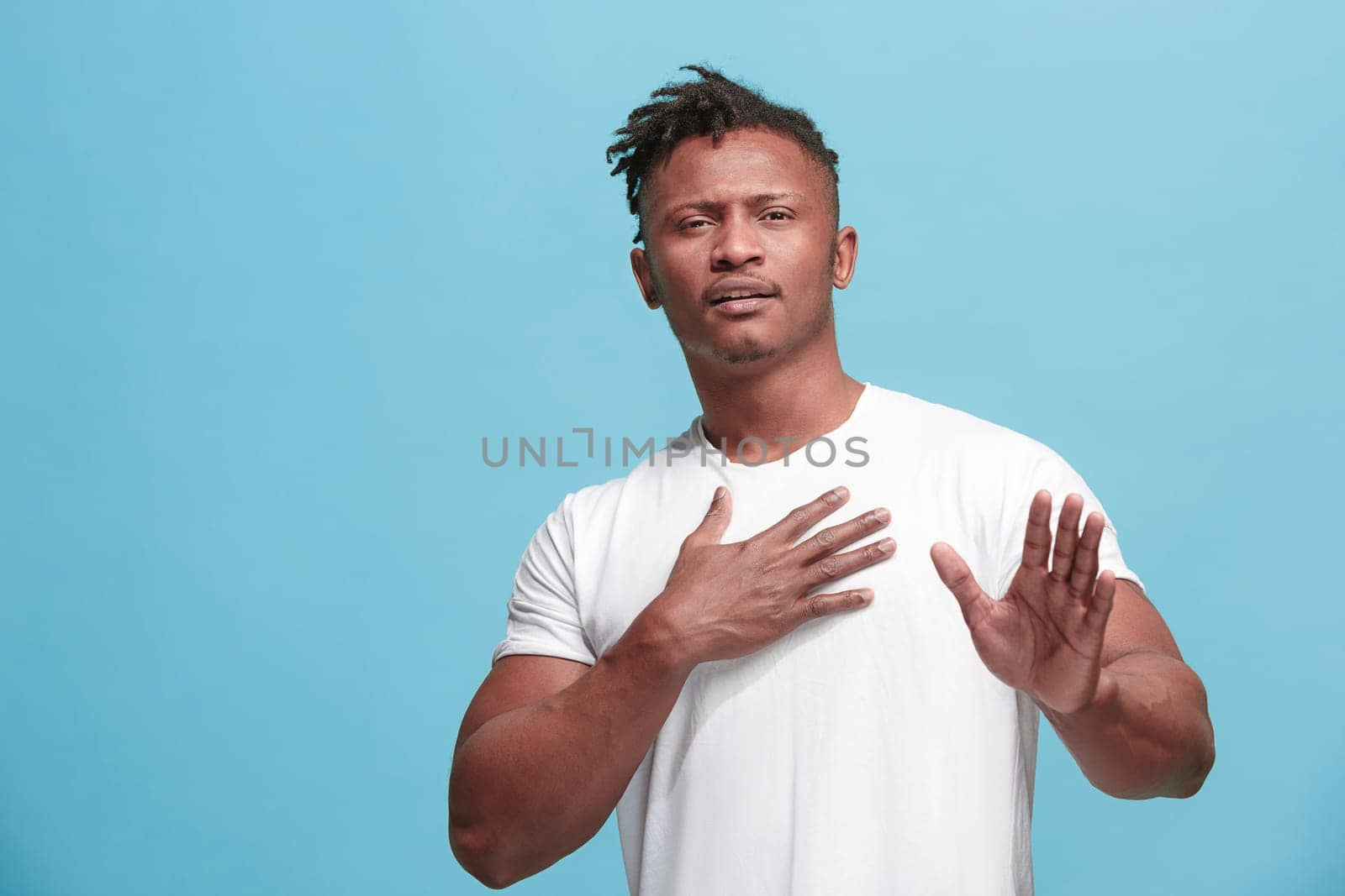 Remember all. Let me think. Doubt concept. Doubtful, thoughtful Afro-Fmerican man remembering something. Young emotional man. Human emotions, facial expression concept. Studio. Isolated on trendy blue