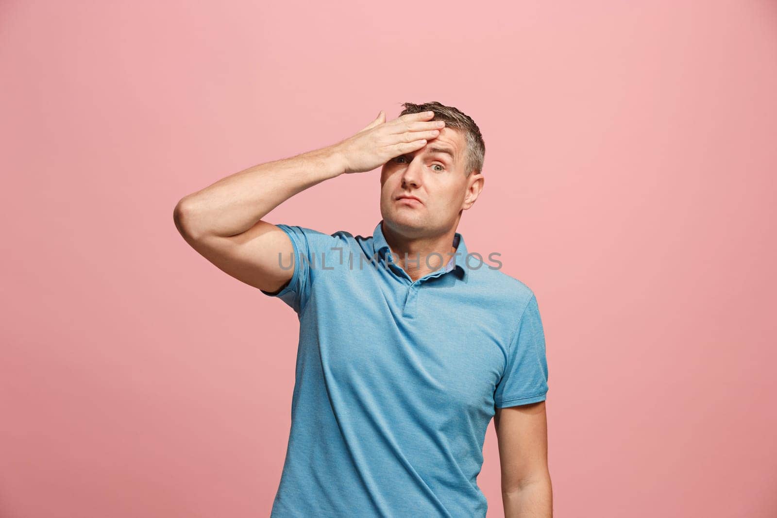 Remember all. Let me think. Doubt concept. Doubtful, thoughtful man remembering something. Young emotional man. Human emotions, facial expression concept. Studio. Isolated on trendy pink. Front
