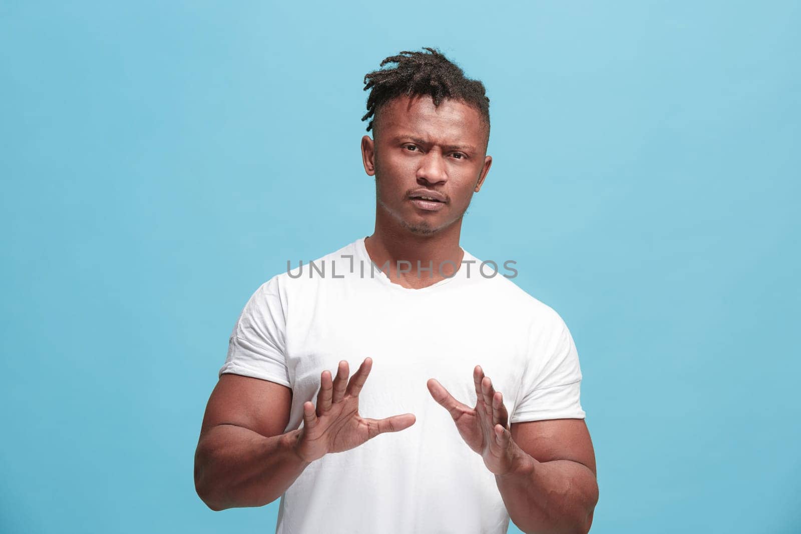 Ew. It's so gross. Young afro man with disgusted expression repulsing something. Disgust concept. Young emotional man. Human emotions, facial expression concept. Studio. Isolated on trendy blue color