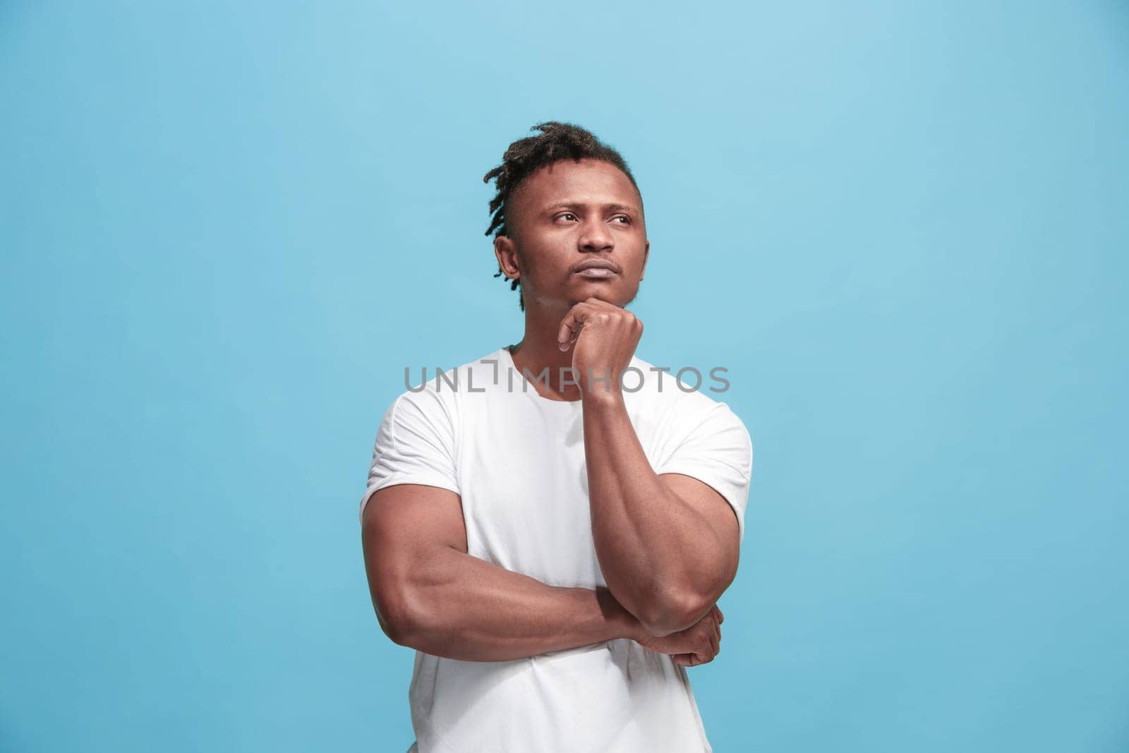 Remember all. Let me think. Doubt concept. Doubtful, thoughtful Afro-Fmerican man remembering something. Young emotional man. Human emotions, facial expression concept. Studio. Isolated on trendy blue