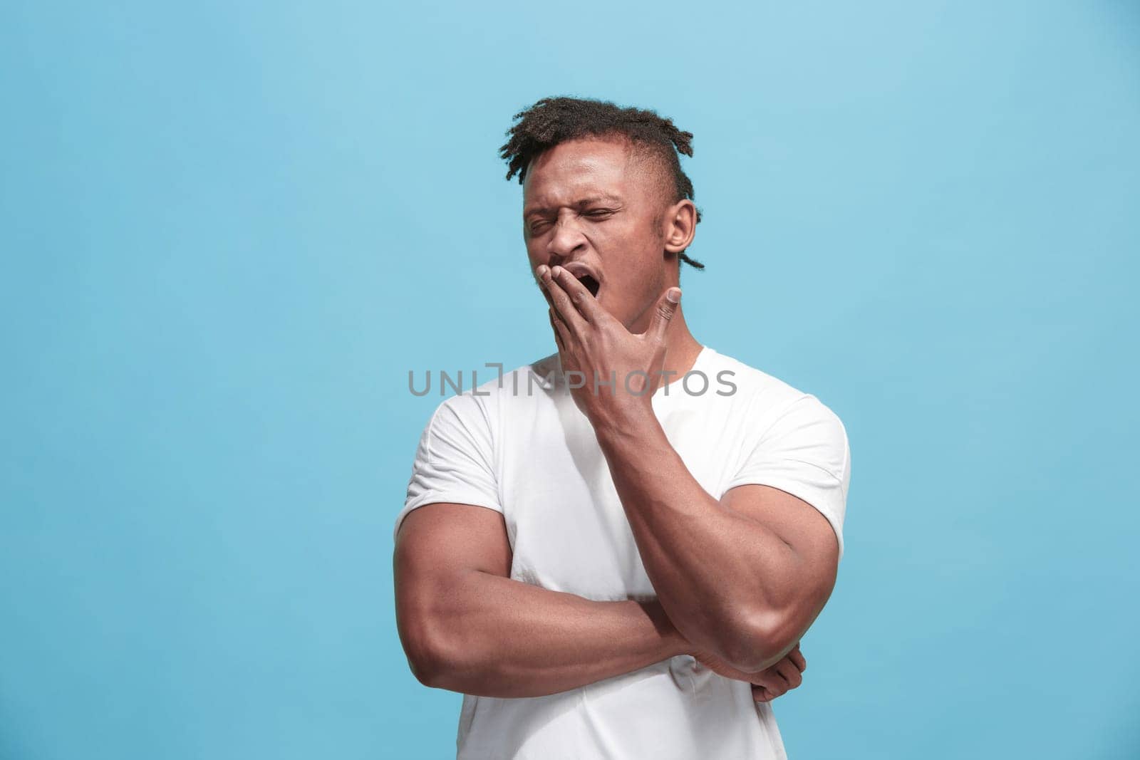 I am tired of everything. Bored man. Boring, dull, tedious concept. Young caucasian emotional man. Human emotions, facial expression concept. Studio Isolated on trendy blue background