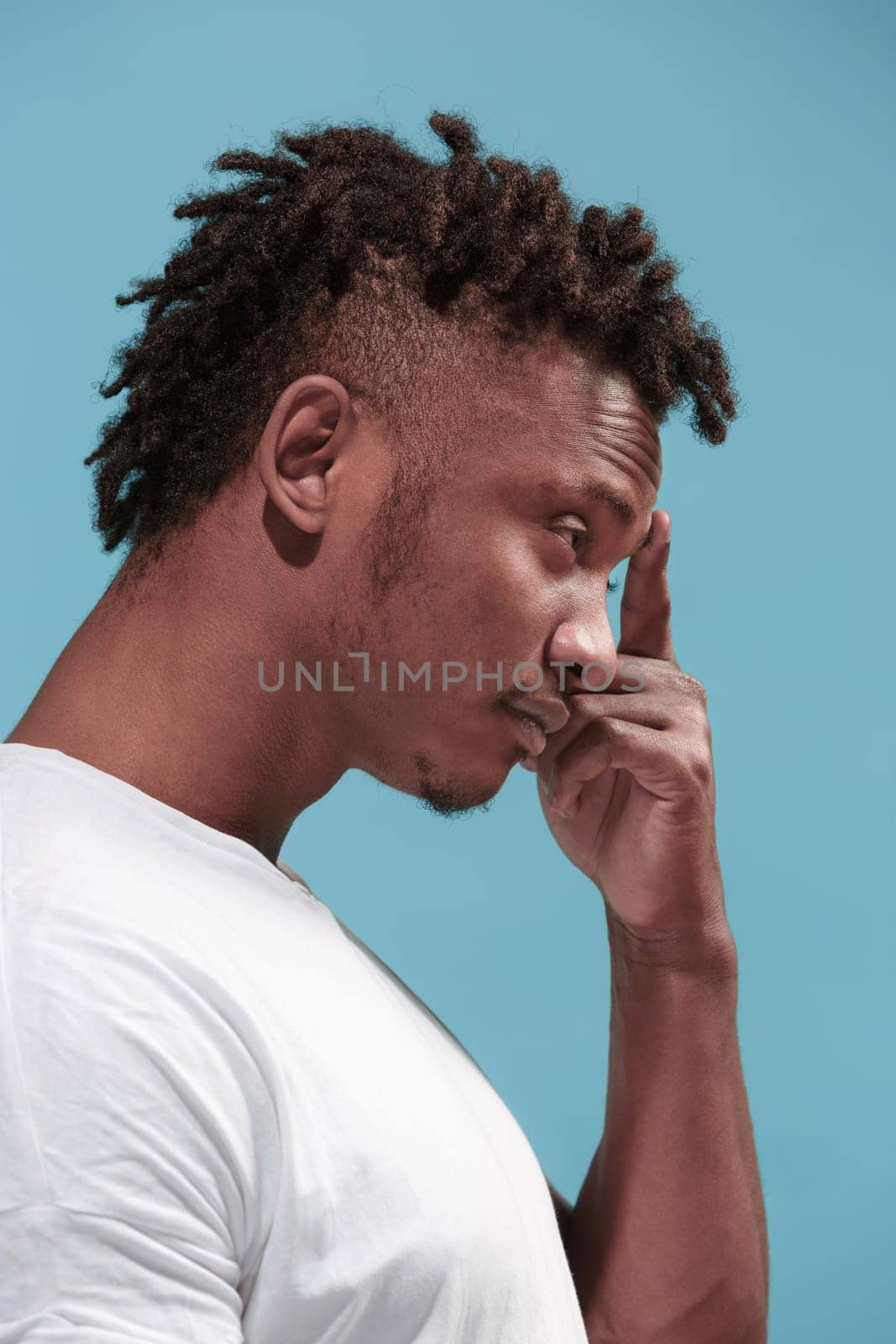 Reject, rejection, doubt concept. Doubtful man with thoughtful expression making choice. Young emotional man. Human emotions, facial expression concept. Profile. Studio. Isolated on trendy blue