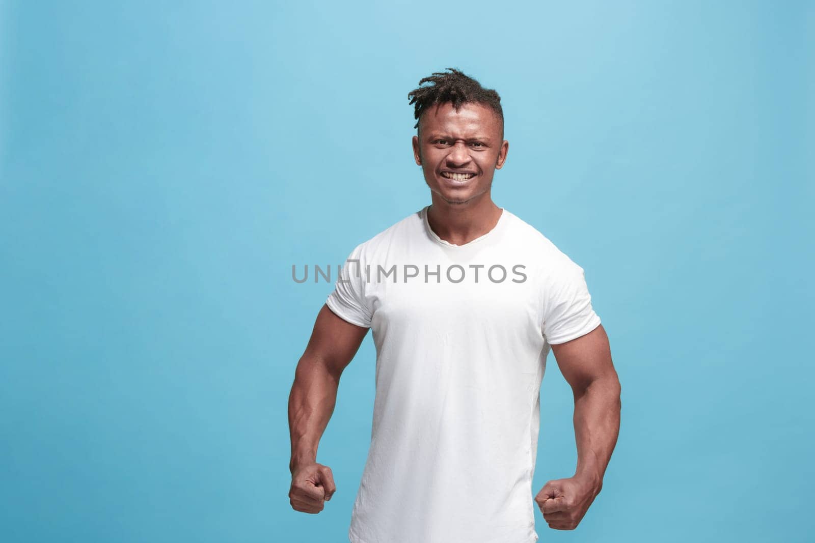 Screaming, hate, rage. Crying emotional angry afro man screaming on blue studio background. Emotional, young face. male half-length portrait. Human emotions, facial expression concept. Trendy colors
