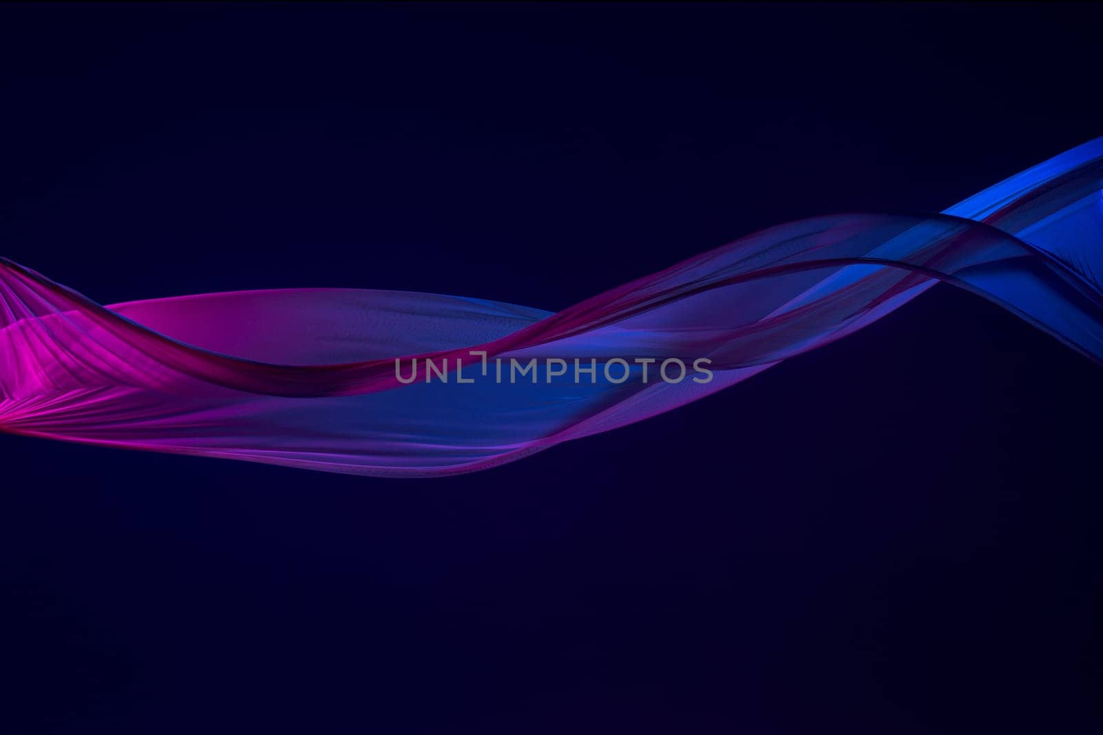 Smooth elegant transparent blue cloth isolated or separated on dark blue studio background. Texture of flying silk fabric.