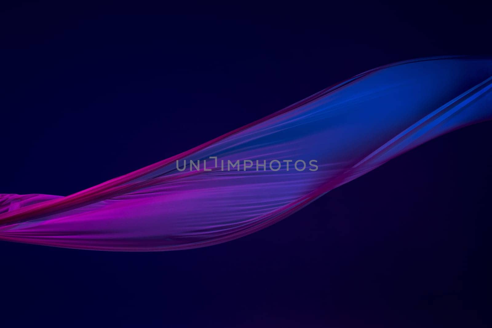 Smooth elegant transparent blue cloth isolated or separated on dark blue studio background. Texture of flying silk fabric.