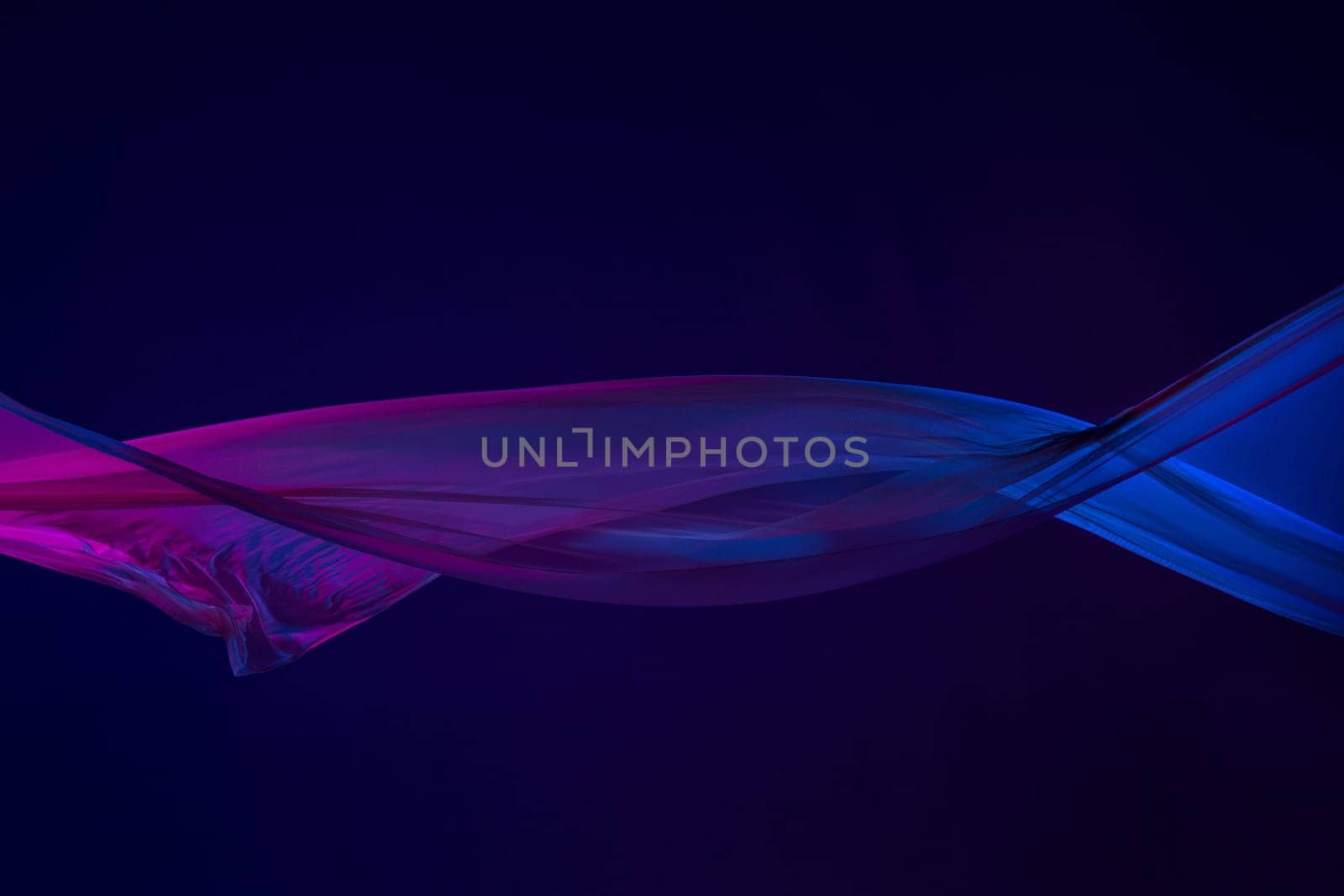 Smooth elegant transparent blue cloth isolated or separated on dark blue studio background. Texture of flying silk fabric.