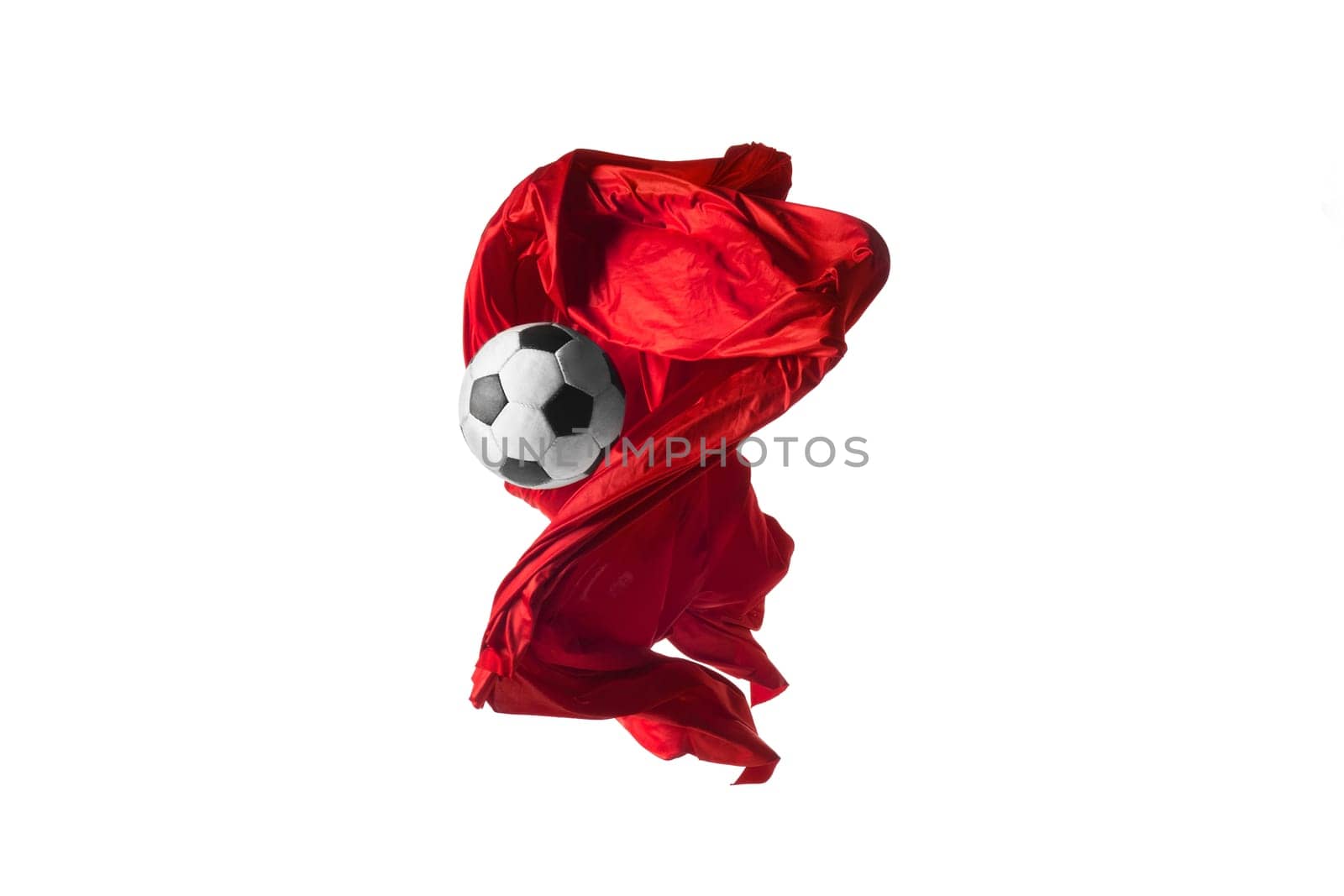Soccer ball and Smooth elegant transparent red cloth isolated or separated on white studio background. Texture of flying fabric. red. Attributes of popular game. Concept of national flag color