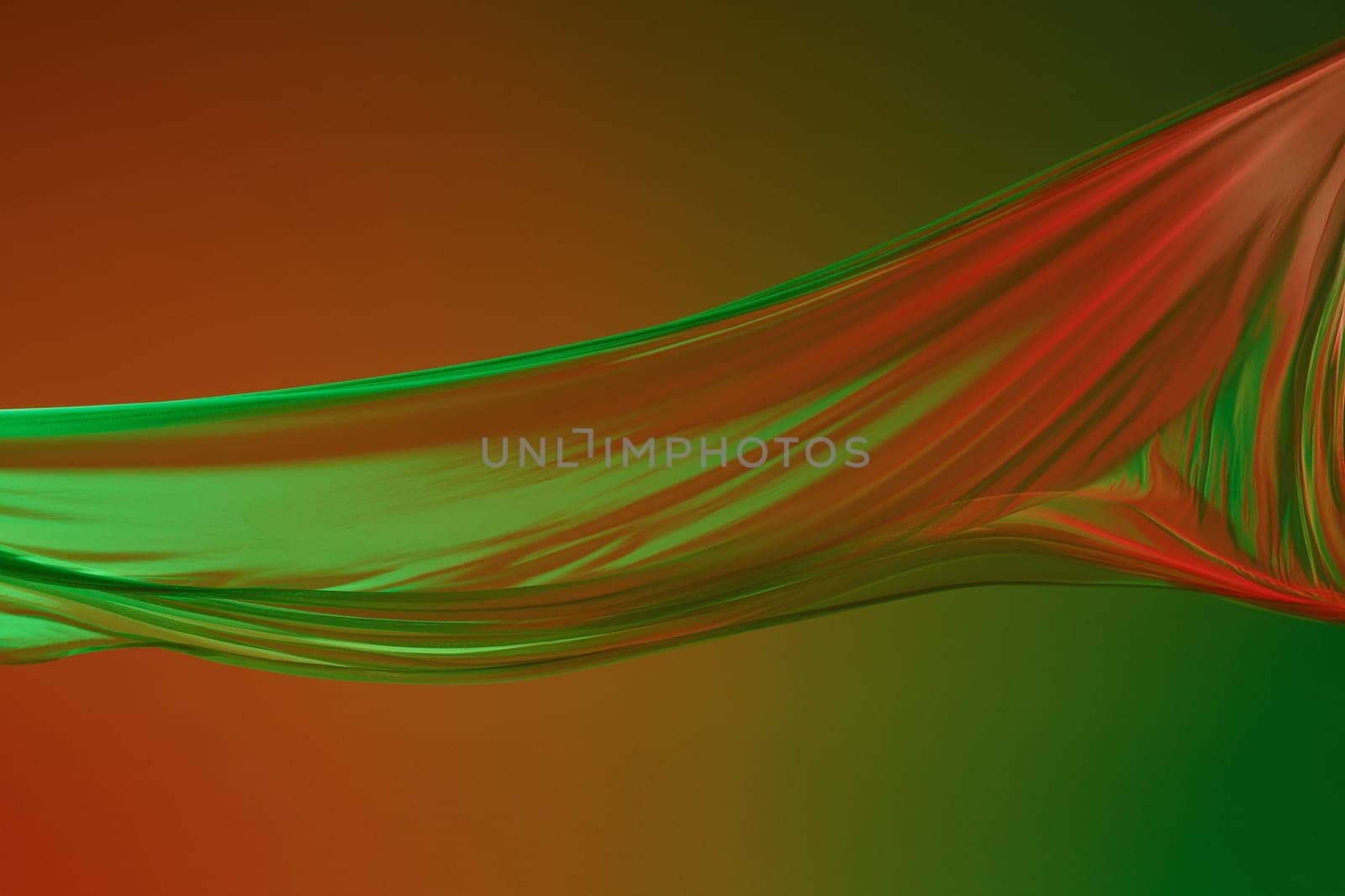 Smooth elegant transparent green cloth isolated or separated on green colored studio background. Texture of flying fabric.