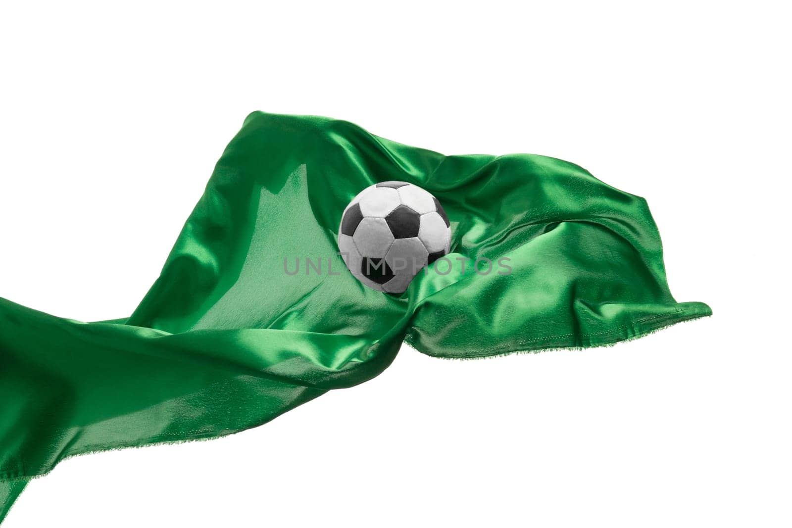 Soccer ball and Smooth elegant transparent green cloth isolated or separated on white studio background. Texture of flying fabric. yellow. Attributes of popular game. Concept of national flag color