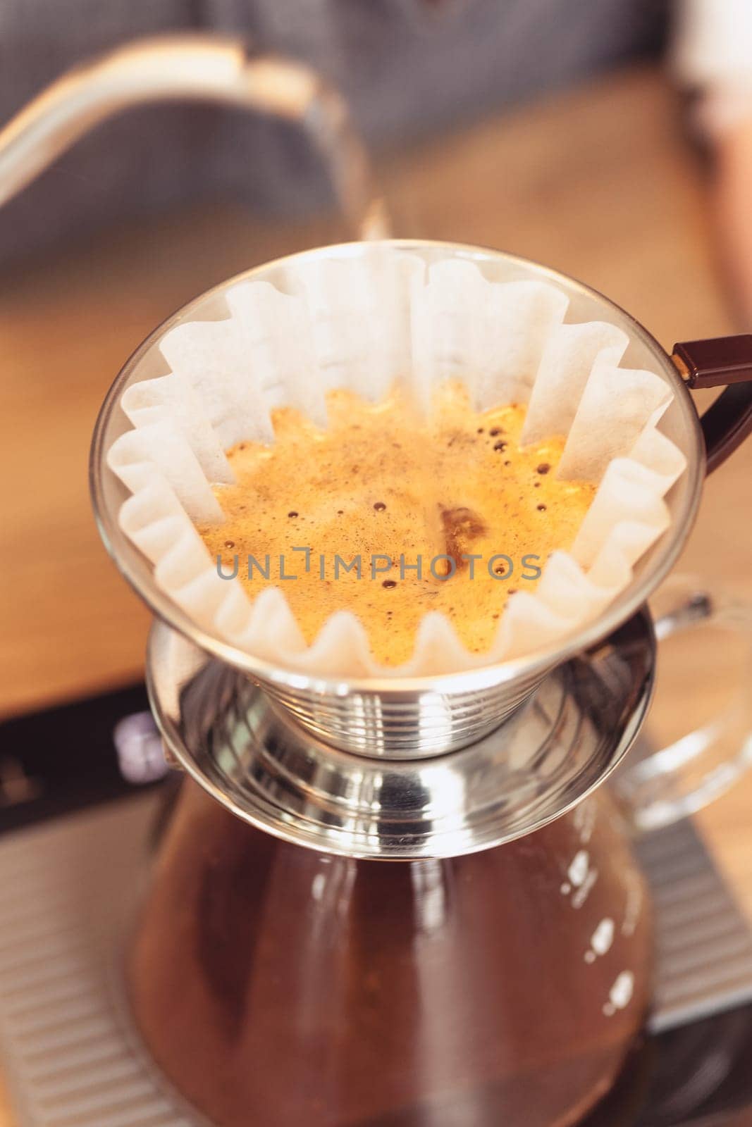 Hand drip coffee, Barista pouring water on coffee ground with filter. Barista, cafe, making coffee, preparation and service concept. Hipster syile