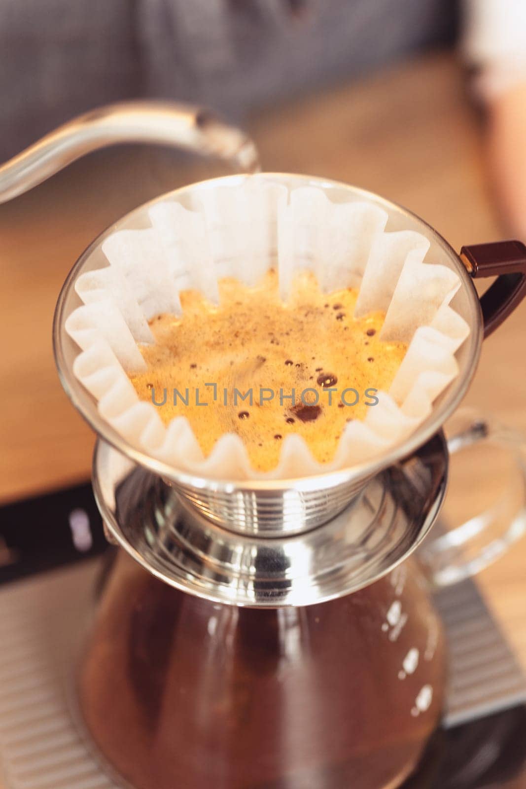 Hand drip coffee, Barista pouring water on coffee ground with filter. Barista, cafe, making coffee, preparation and service concept. Hipster syile