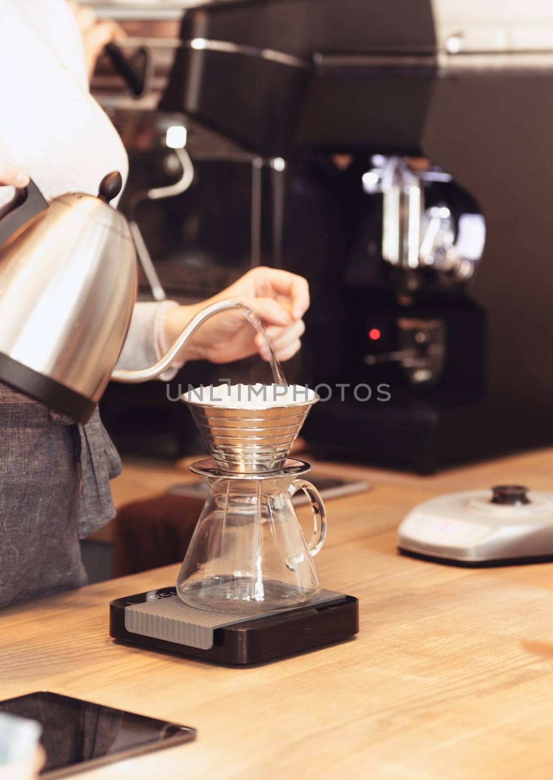 Hand drip coffee, Barista pouring water on coffee ground with filter. Barista, cafe, making coffee, preparation and service concept. Hipster syile