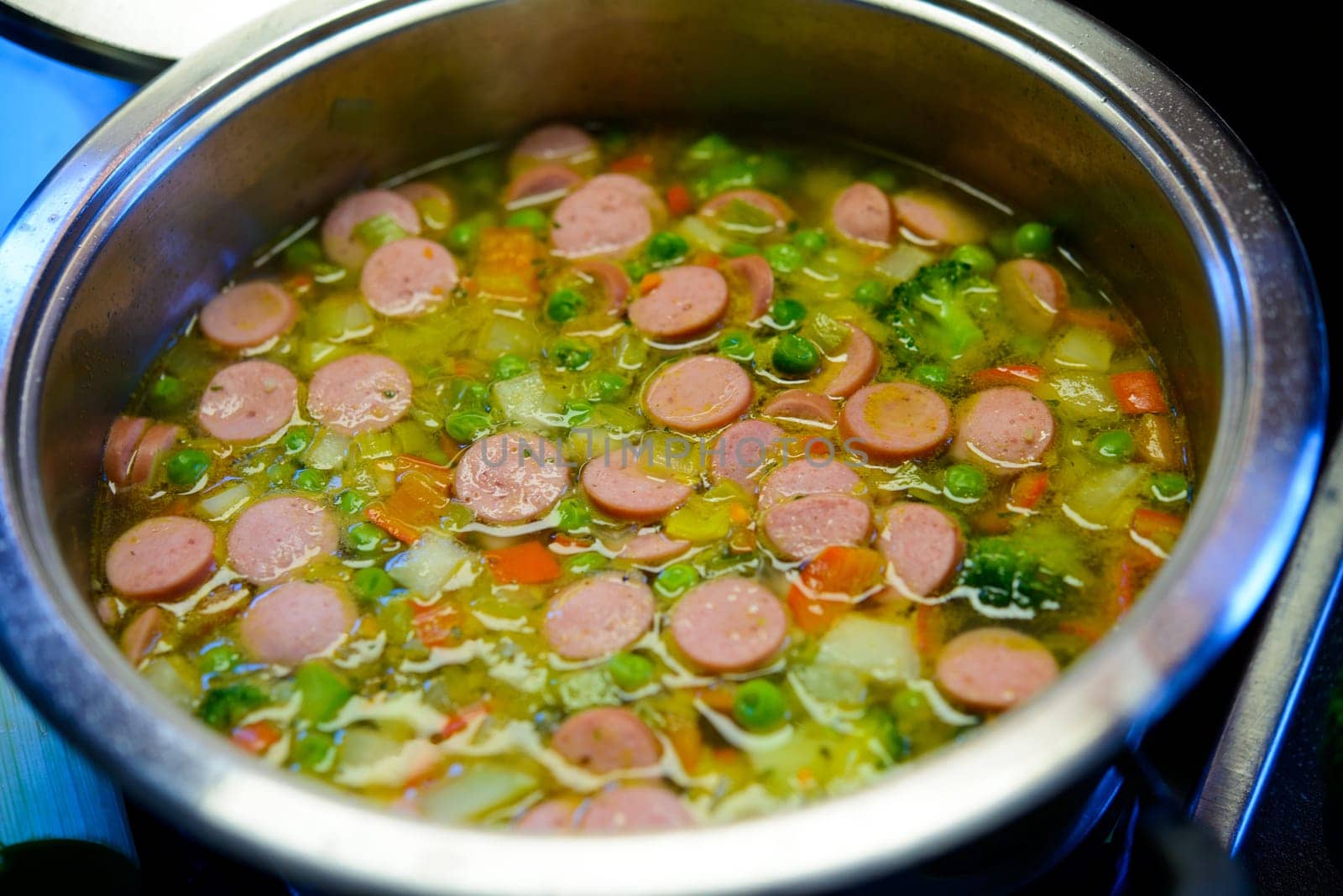 vegetable soup in pot on stove with leek and bread