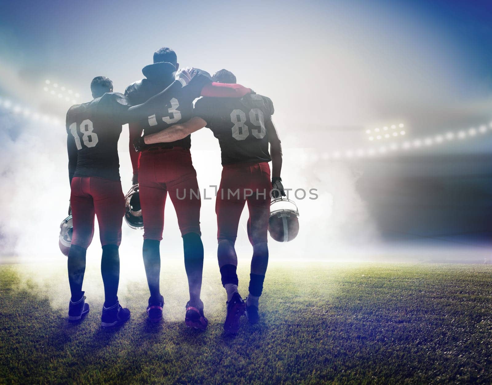 The back view of three caucasian fitness men as american football players on stadium background