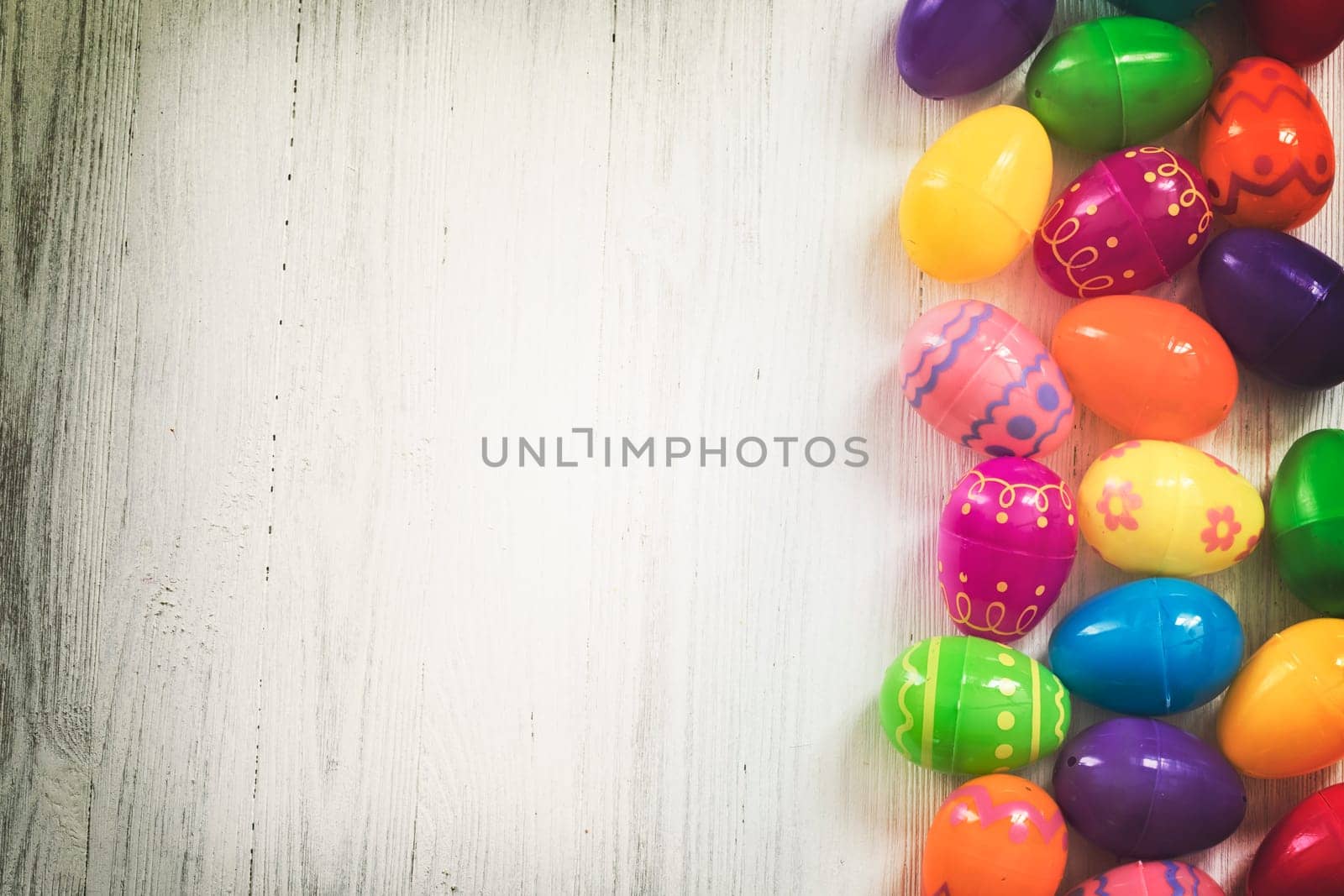 Multi colored Easte eggs on white wooden background