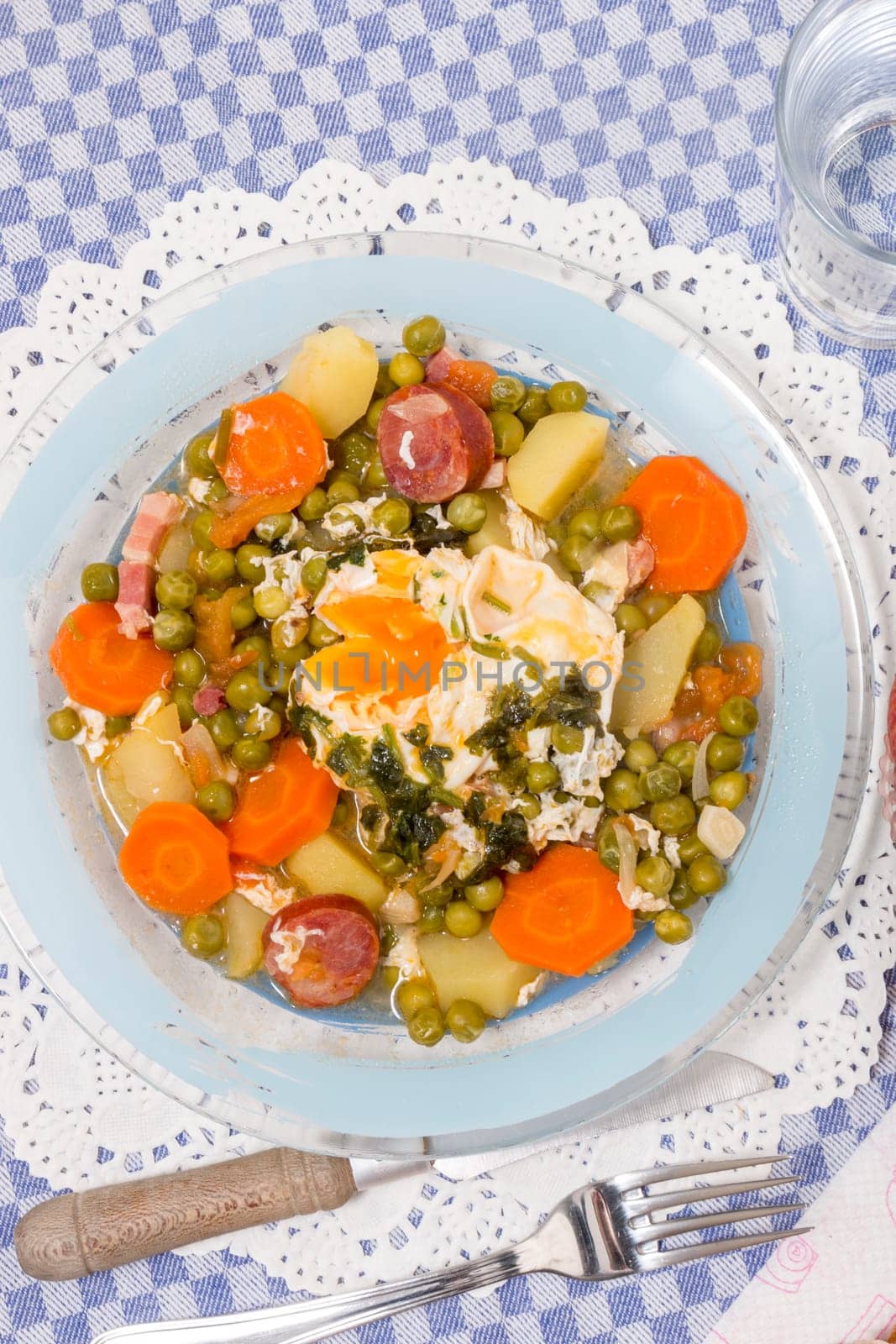Traditional portuguese culinary meal of green peas with egg, potatoes and carrots.