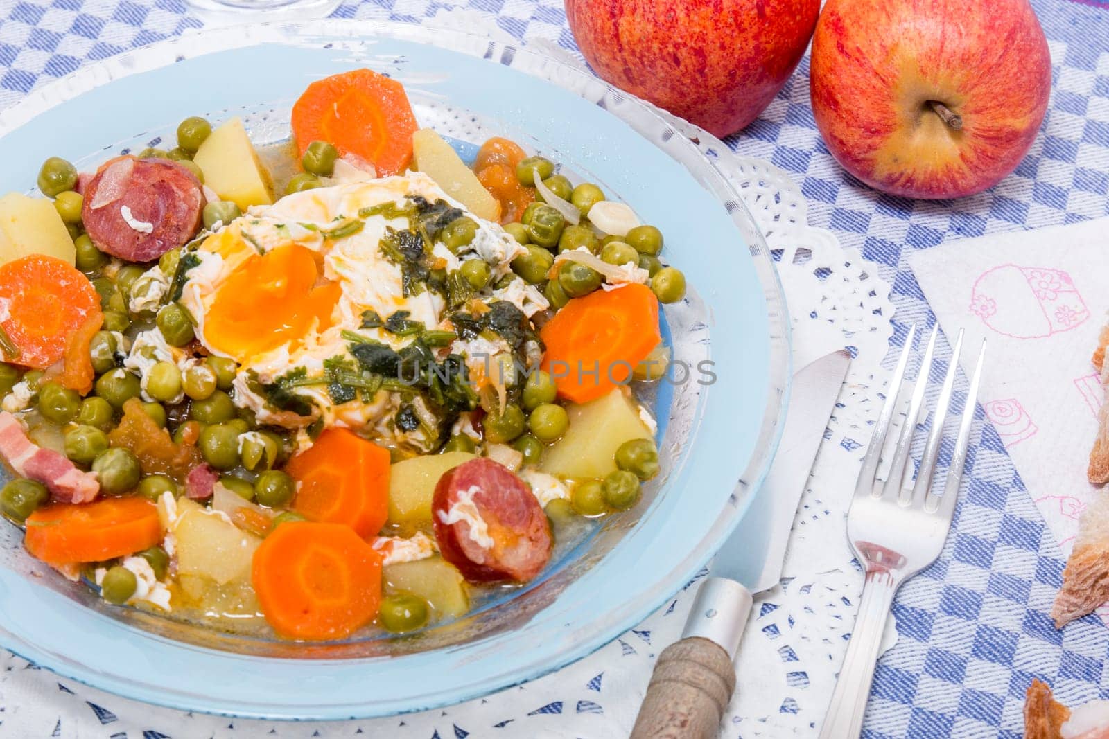 Traditional portuguese culinary meal of green peas with egg, potatoes and carrots.