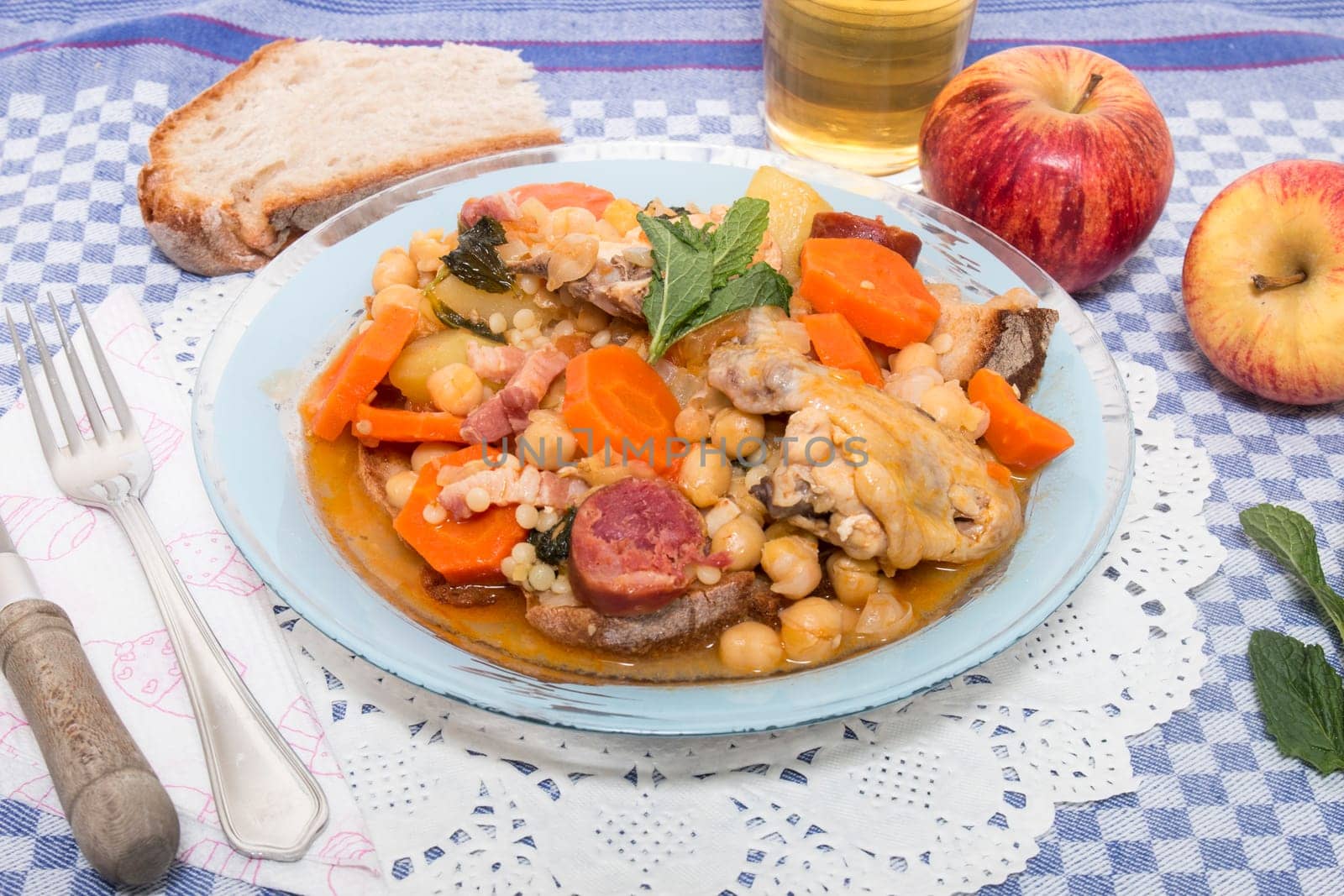 Traditional portuguese meal of Chickpeas with chicken, carrot and chorizo.