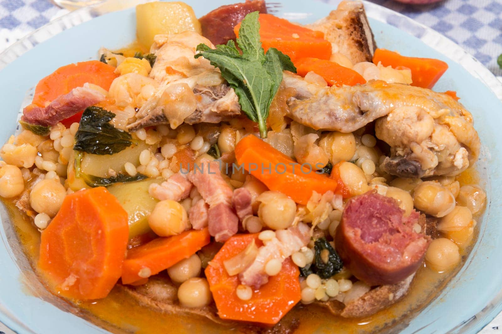 Traditional portuguese meal of Chickpeas with chicken, carrot and chorizo.