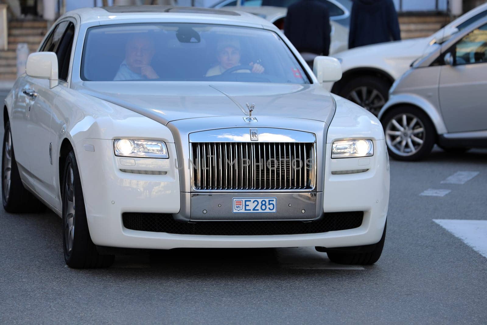 Monte-Carlo, Monaco - March 17, 2018: Woman Driving An Expensive White Rolls-Royce in Front of the Monte-Carlo Casino in Monaco in The French Rivier