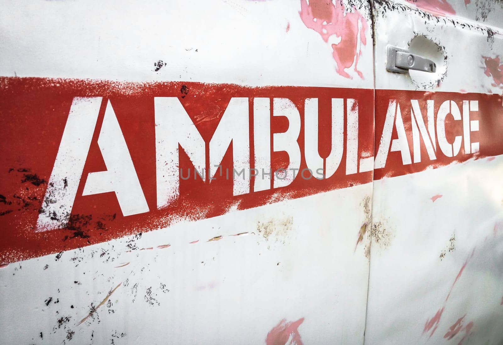 Masha and the Bear ambulance. Reproduction of the vehicle of the original animated series. Details of the characteristic rusty side panel. Bergamo, ITALY - August 28, 2017.