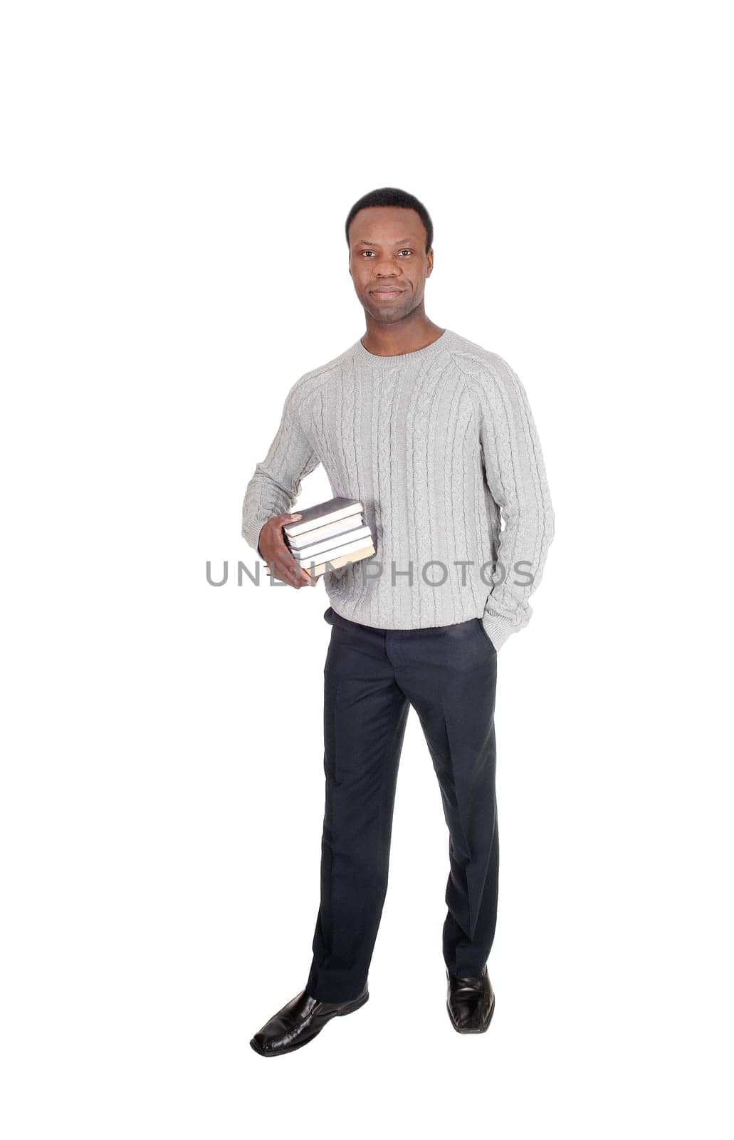 A handsome serious young African American man standing and holding.his books in his hands, isolated for white background.