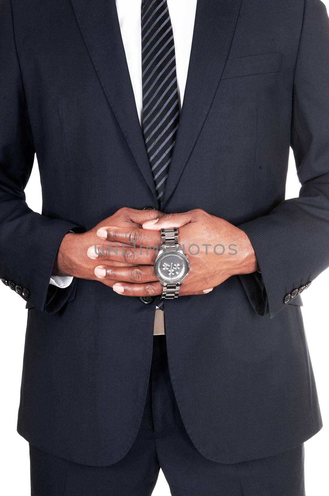 The middle section of an African man in a dark suit holding his wrist.watch in his hands, isolated for white background.