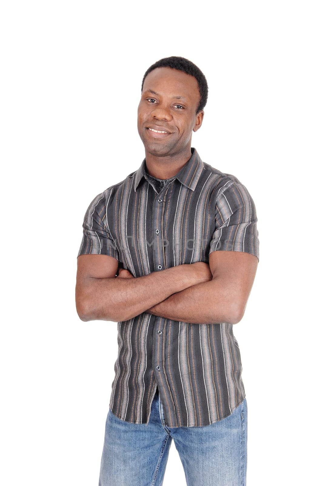 A tall good looking African American man standing in jeans and.a striped shirt from the front, isolated for white background.
