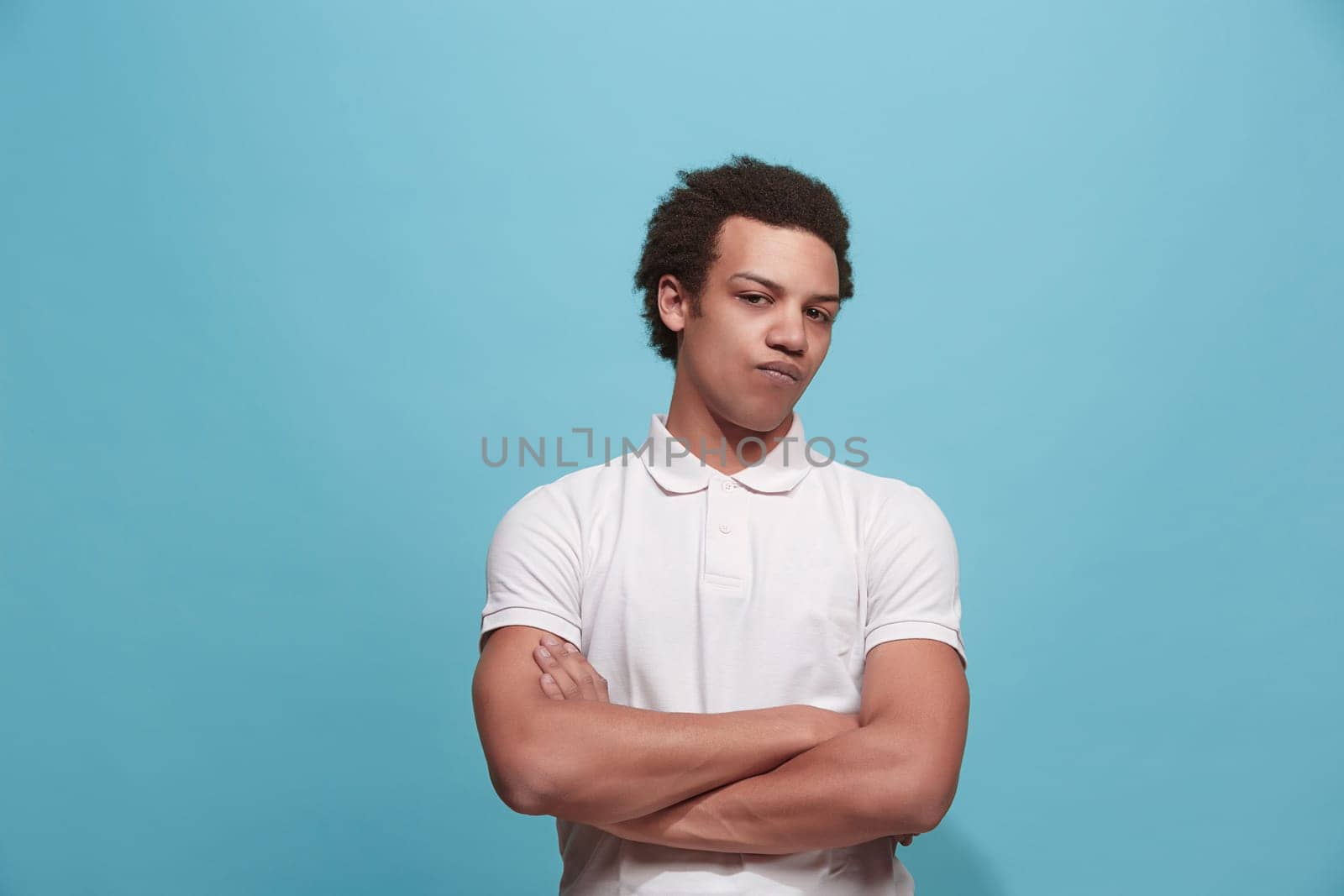 Suspicion. Doubt, mistrust, distrust concept. Doubtful man looking with disbelief expression . Young emotional man. Human emotions, facial expression concept. Studio. Isolated on trendy blue