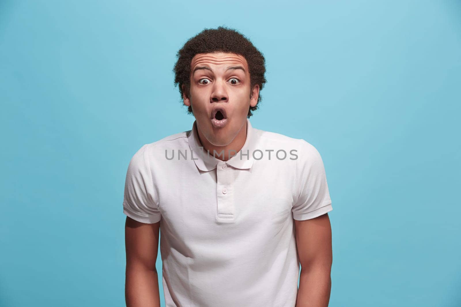 Wow. Attractive male half-length front portrait on pink studio backgroud. Young emotional surprised bearded man standing with open mouth. Human emotions, facial expression concept. Trendy colors