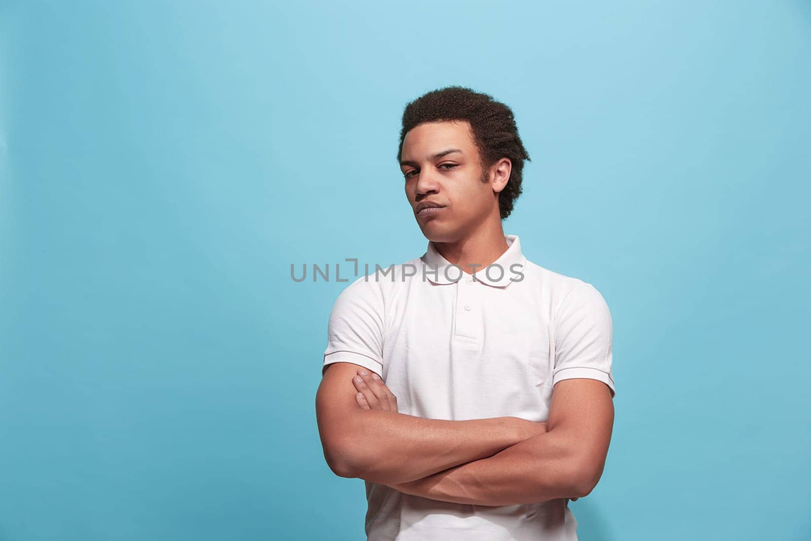 Suspicion. Doubt, mistrust, distrust concept. Doubtful man looking with disbelief expression . Young emotional man. Human emotions, facial expression concept. Studio. Isolated on trendy blue