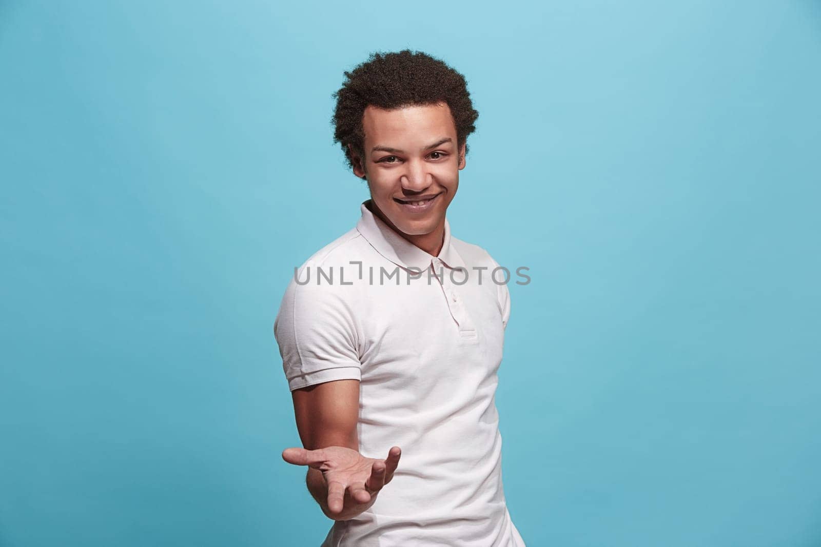 Argue, arguing concept. Beautiful male half-length portrait isolated on blue studio backgroud. Young emotional surprised man looking at camera. Human emotions, facial expression concept. Front view