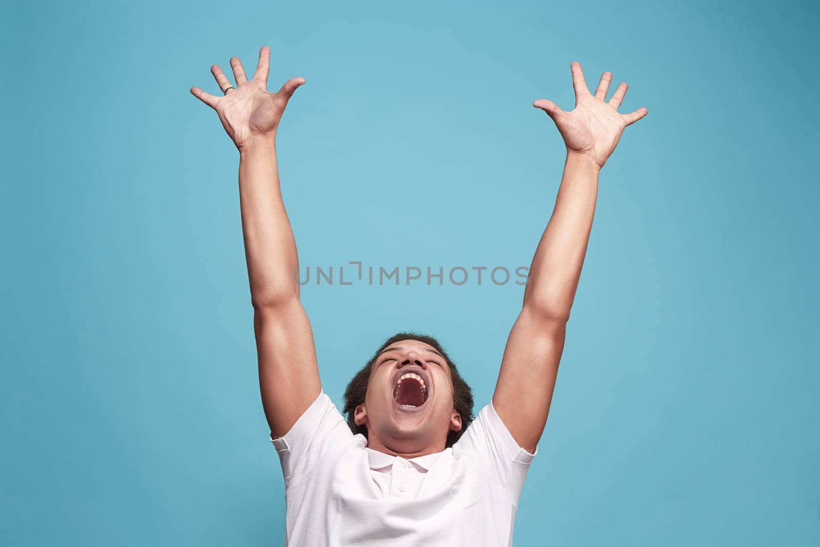 I won. Winning success happy man celebrating being a winner. Dynamic image of caucasian male model on blue studio background. Victory, delight concept. Human facial emotions concept. Trendy colors