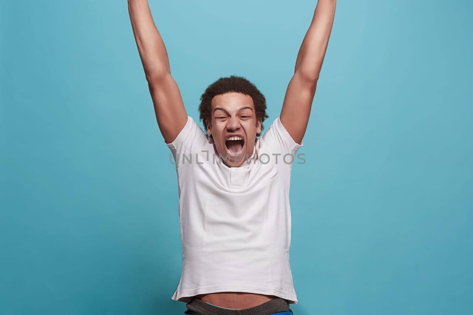 I won. Winning success happy man celebrating being a winner. Dynamic image of caucasian male model on blue studio background. Victory, delight concept. Human facial emotions concept. Trendy colors